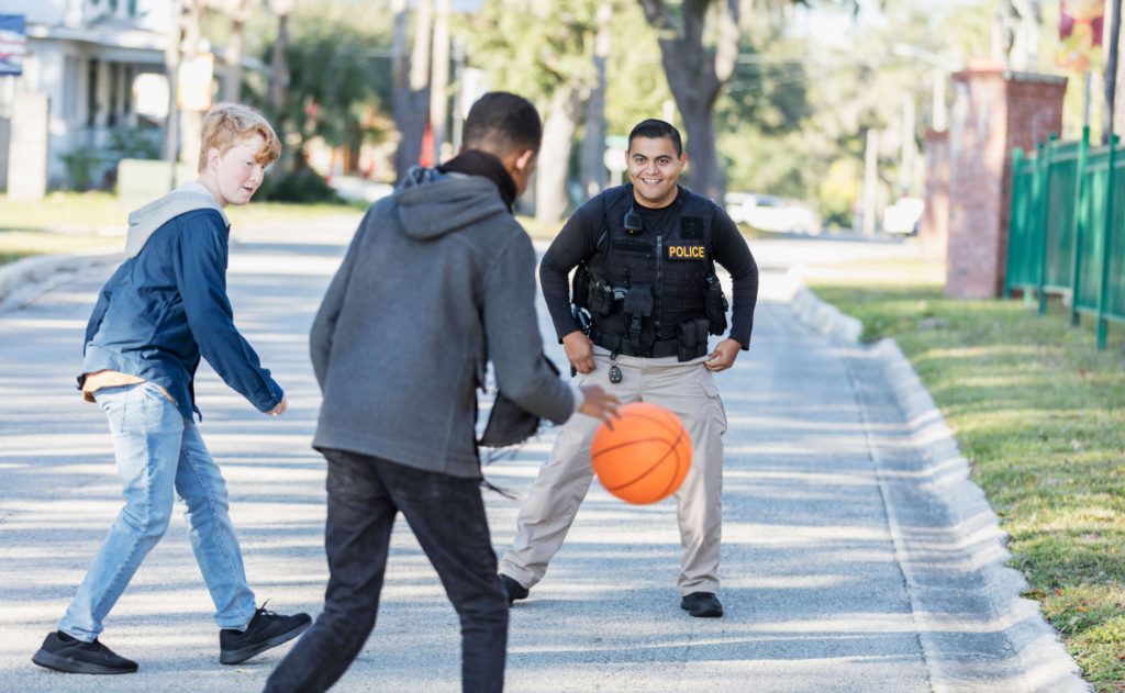 police officer playing basketball
